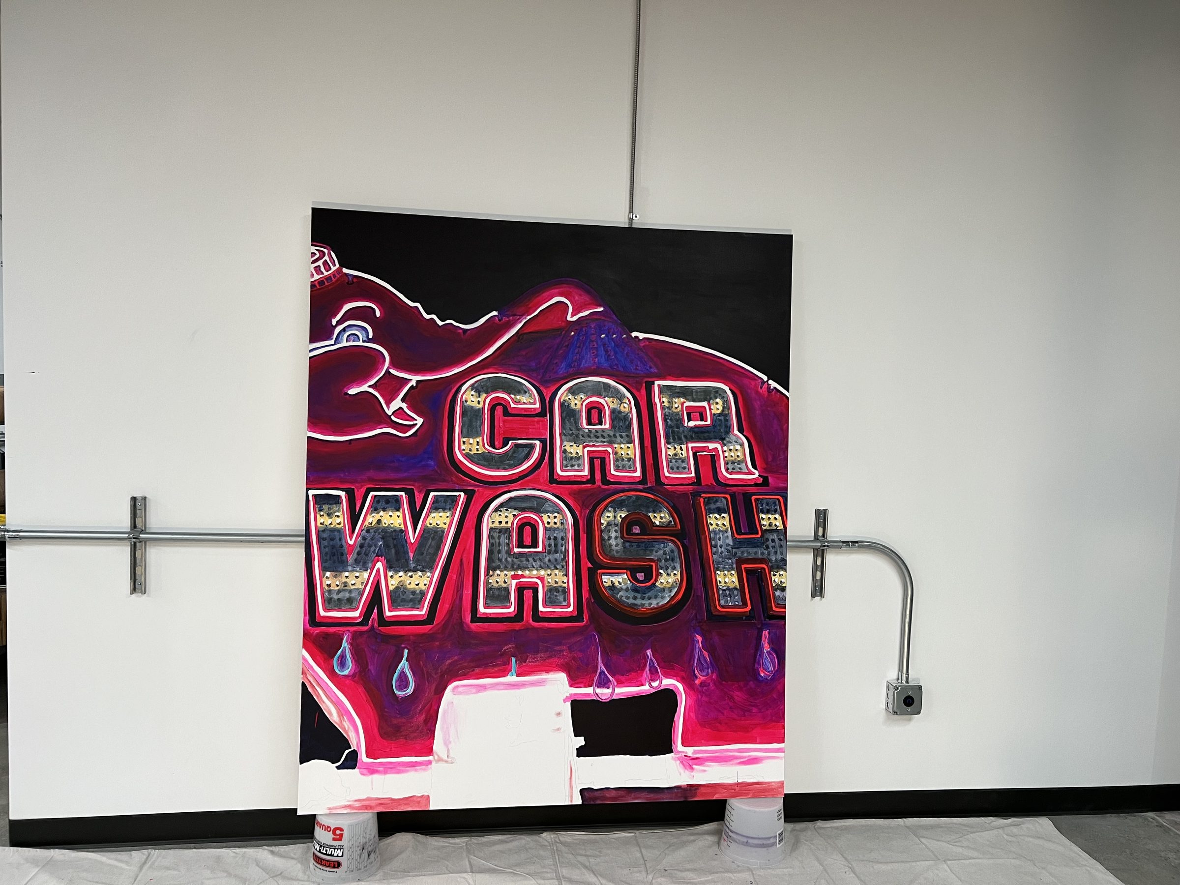 The finished CAR WASH panel propped against a clean white wall, gallery-ready.