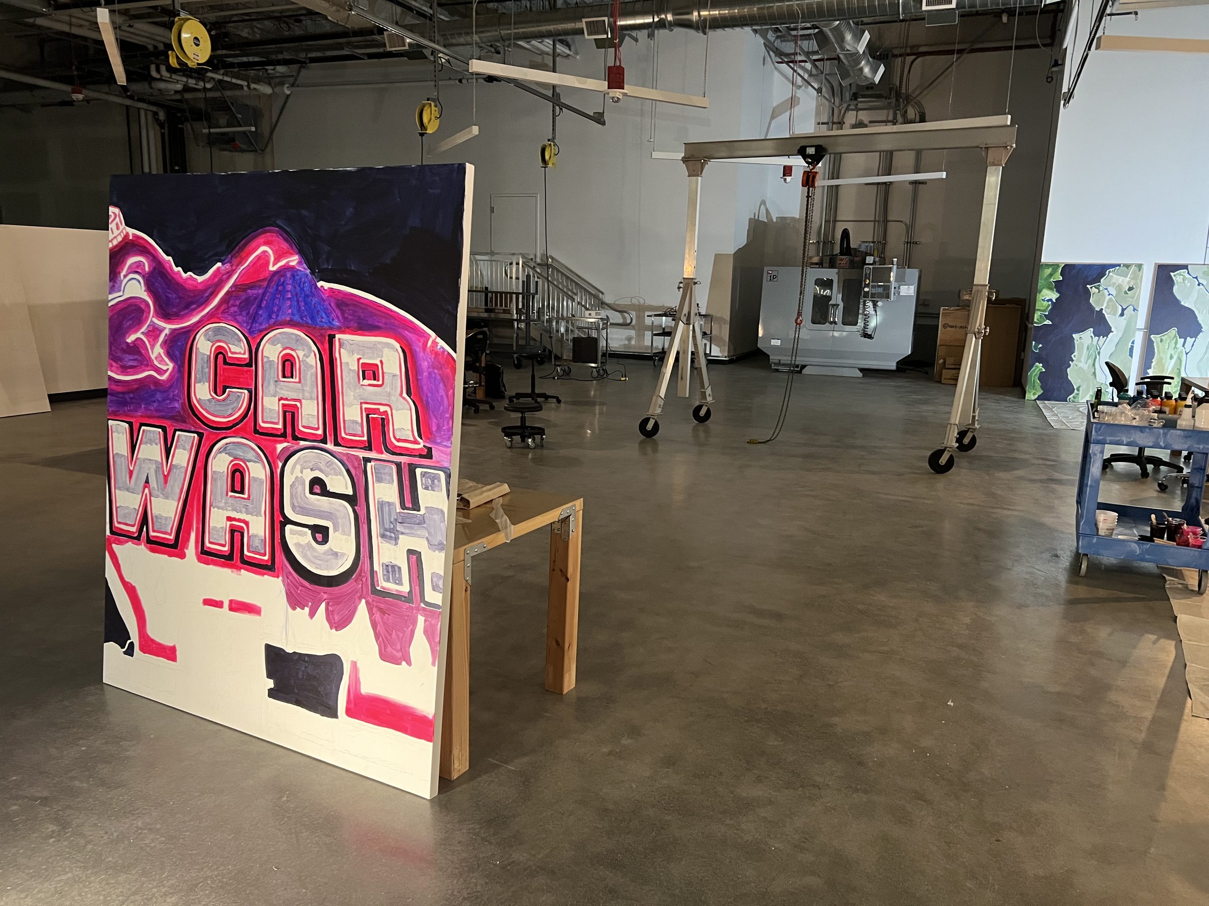 The completed CAR WASH panel propped on the studio floor before opening.