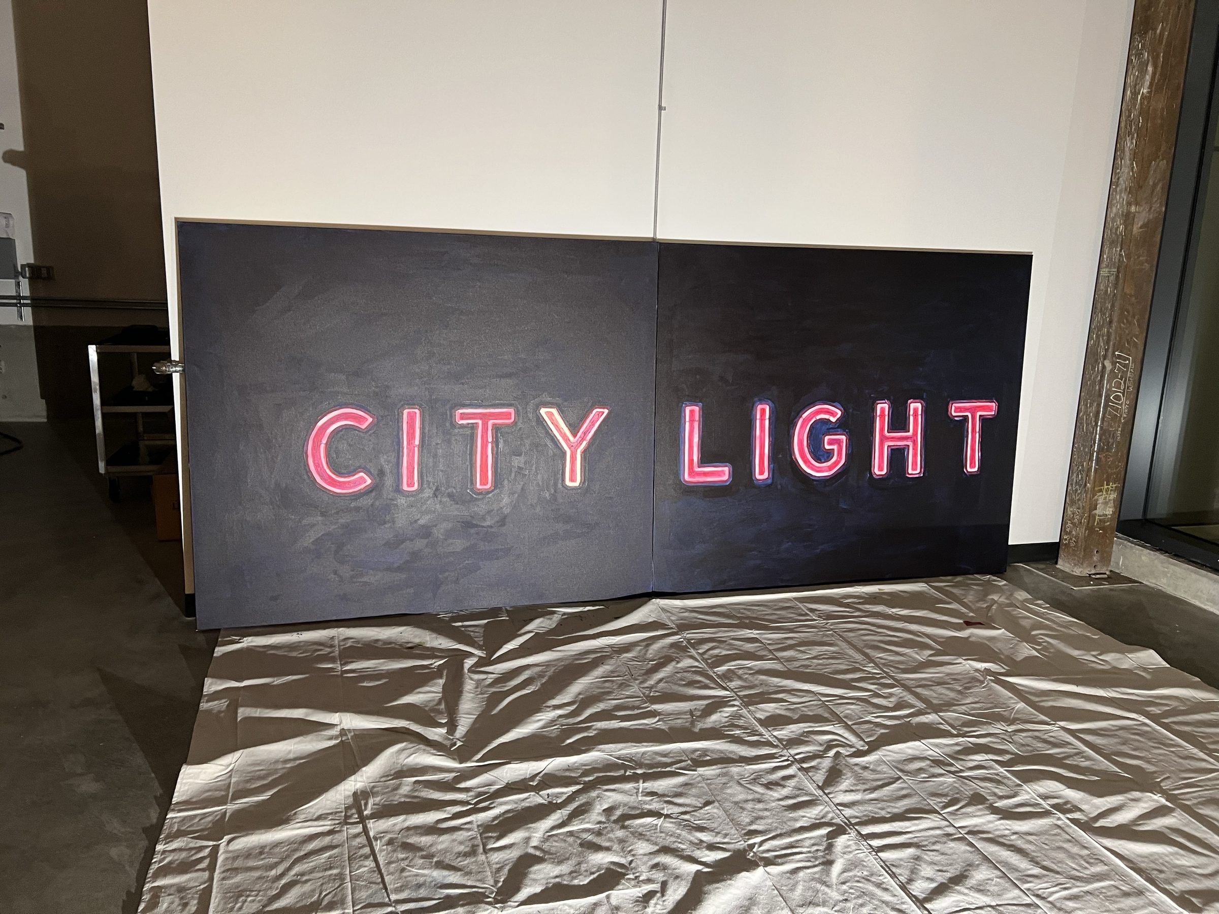 The CITY LIGHT title piece laid out in the gallery before mounting.
