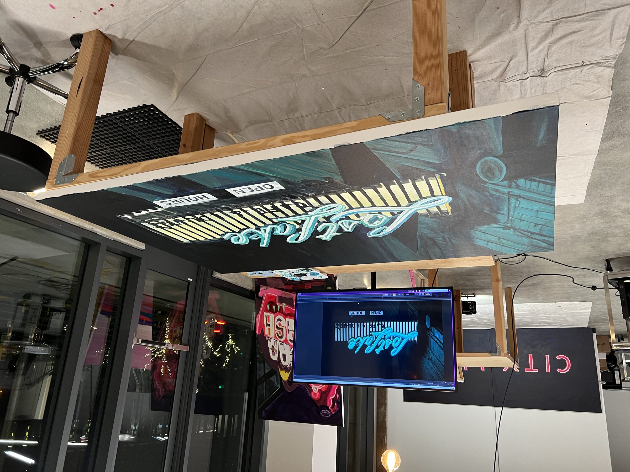 CITY LIGHT pieces installed near the gallery window — daylight wash, neon palette.