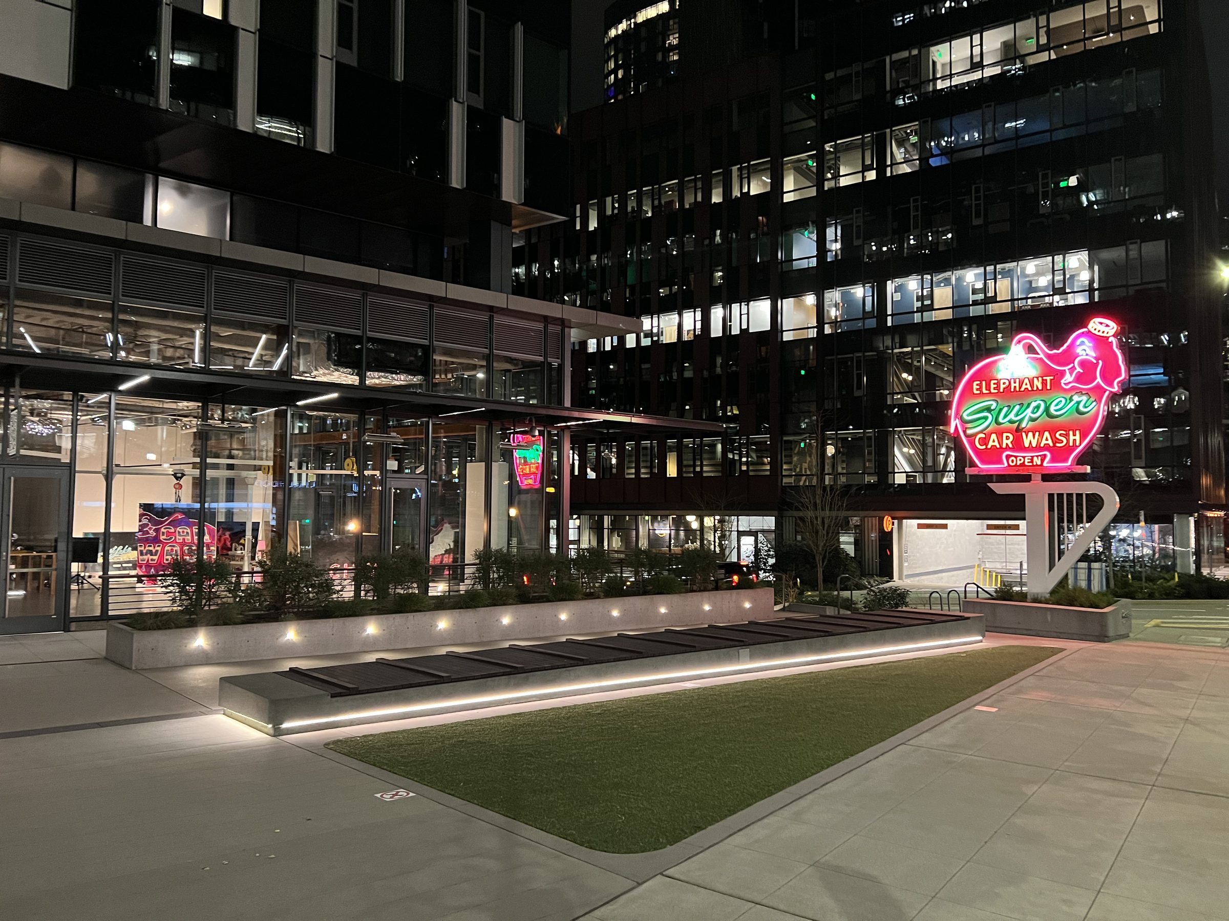 Opening night — Pink Elephant Car Wash painting and CITY LIGHT marquee lit against the dark plaza.
