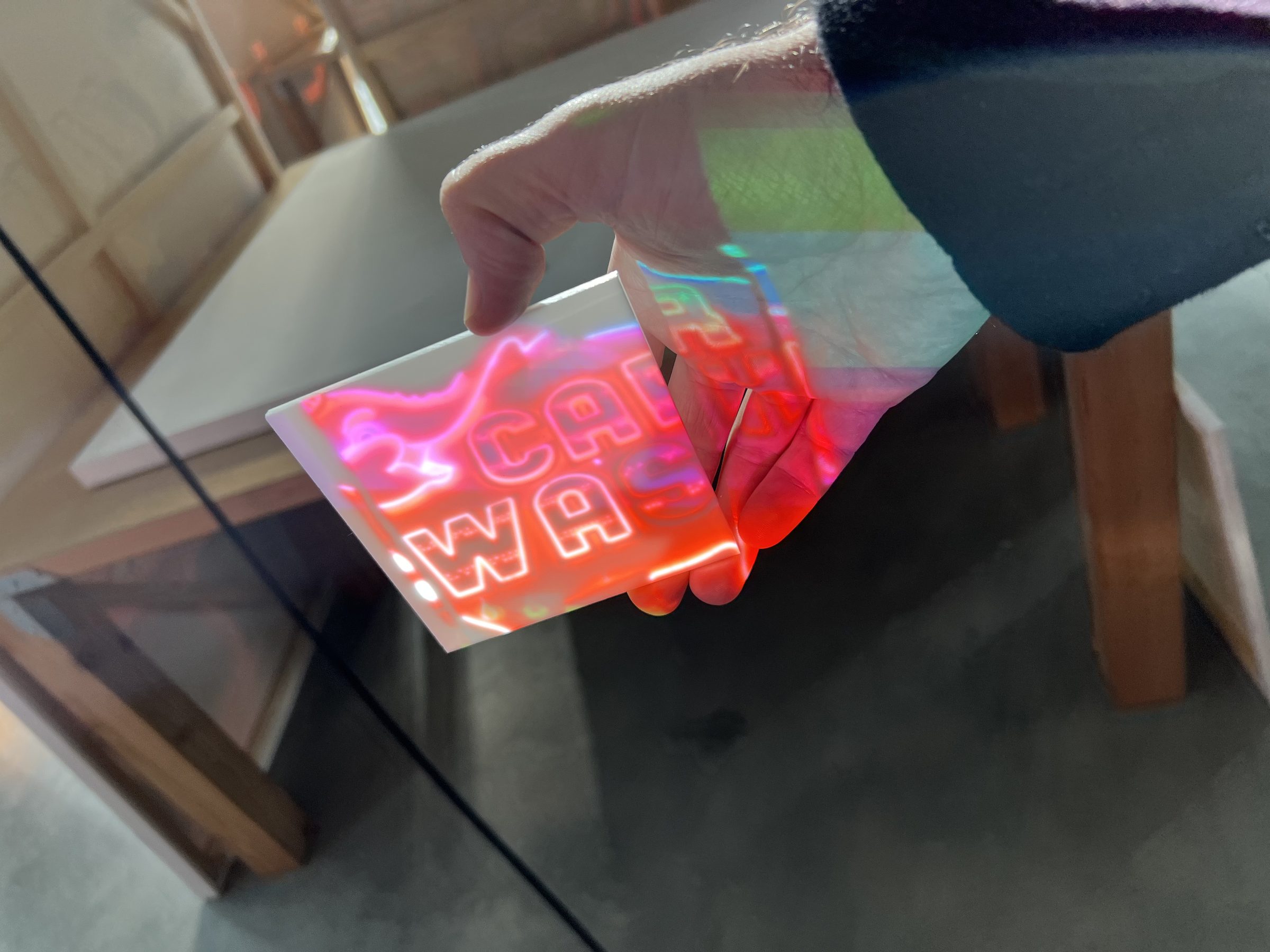 Holographic CAR WASH decal — editioned ephemera distributed at the opening.